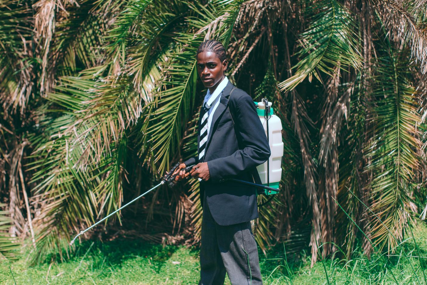 Farmer applying crop treatment in a field in Ghana